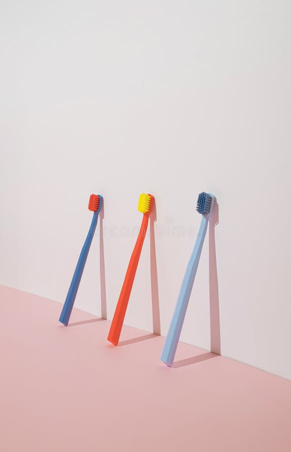Trendy Minimal Composition with Three Colorful Toothbrushes on Pastel ...