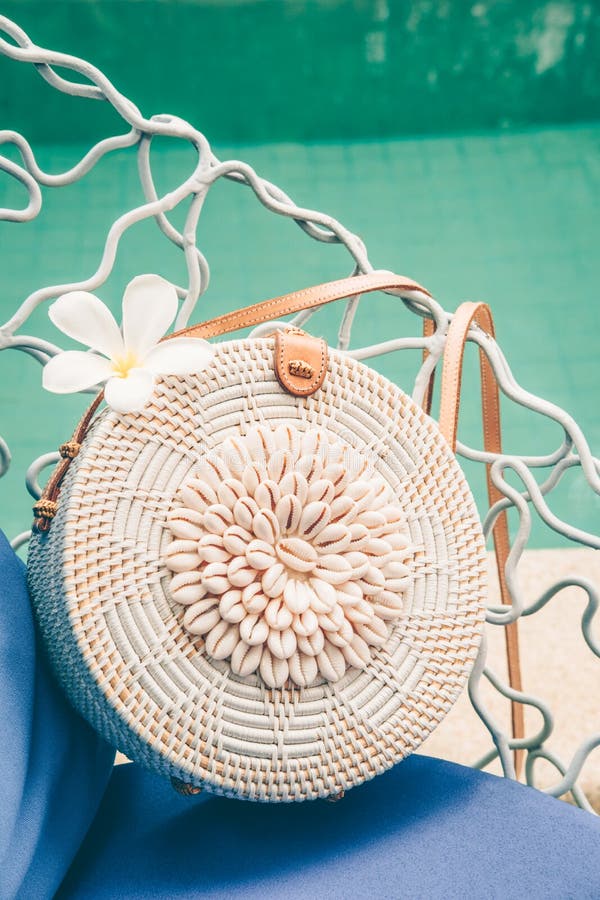 Trendy Round Crossbody Straw Bag With Seashells And Flower On The Beautiful Lounge Chair Near A ...