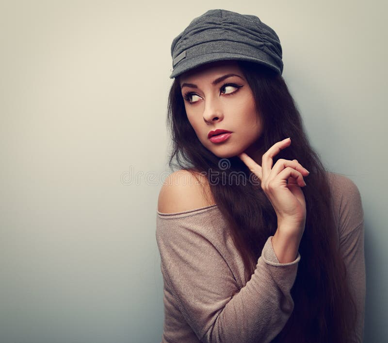 Trendy Thinking Female in Cap Looking. Vintage Color Portrait Stock