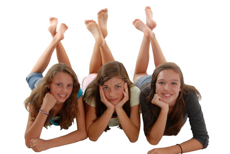 Tres adolescentes que ponen en la barbilla del suelo a disposición