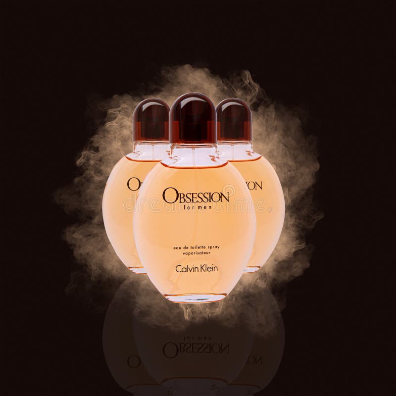 Tres botellas de obsesión para hombres eau de retrete de Calvin Klein en un oscuro fondo polvoriento fotos de archivo Tres botellas de obsesión para hombres eau de retrete de Calvin Klein en un oscuro fondo polvoriento fotos de archivo