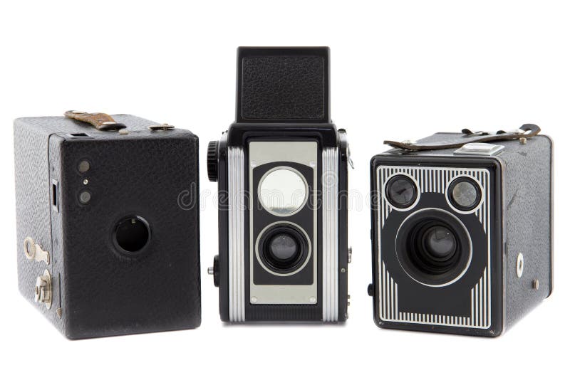 Three retro photo cameras on a row isolated. Three retro photo cameras on a row isolated