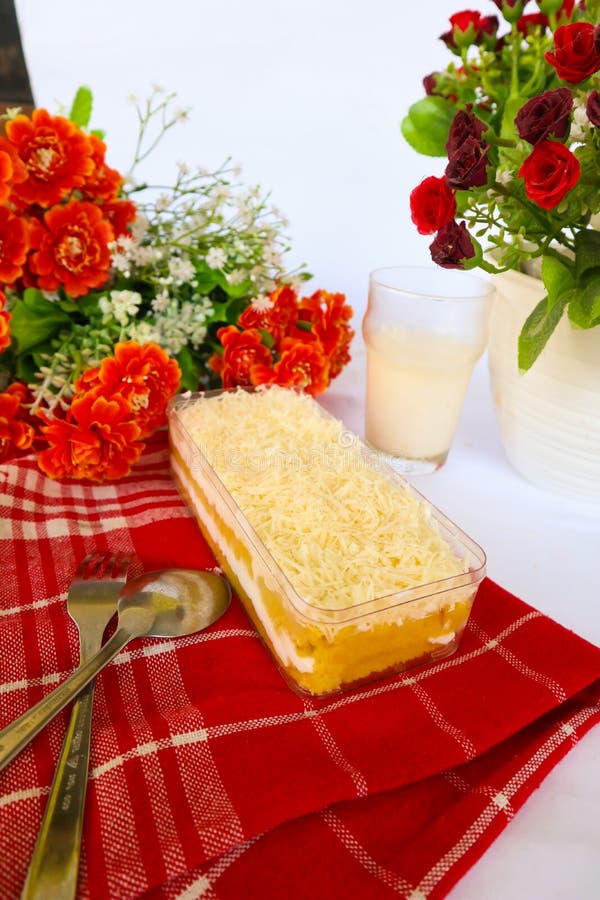 Tres Leches Cake or Milk Bath Served with Milk Spoon and Fork, Isolated