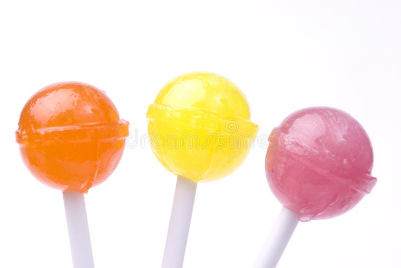 Three different coloured candy sticks on white background. Three different coloured candy sticks on white background