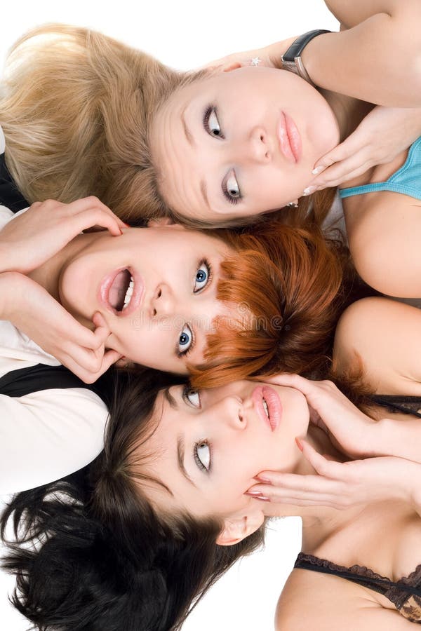 Portrait of three amazed women touching their cheeks on white background. Portrait of three amazed women touching their cheeks on white background