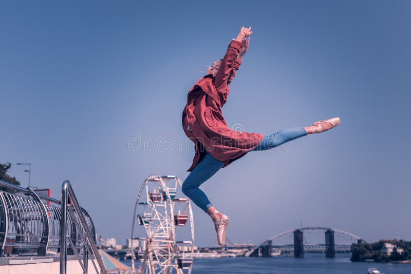 This is freedom. Nice happy woman feeling absolute freedom while jumping into the air. This is freedom. Nice happy woman feeling absolute freedom while jumping into the air