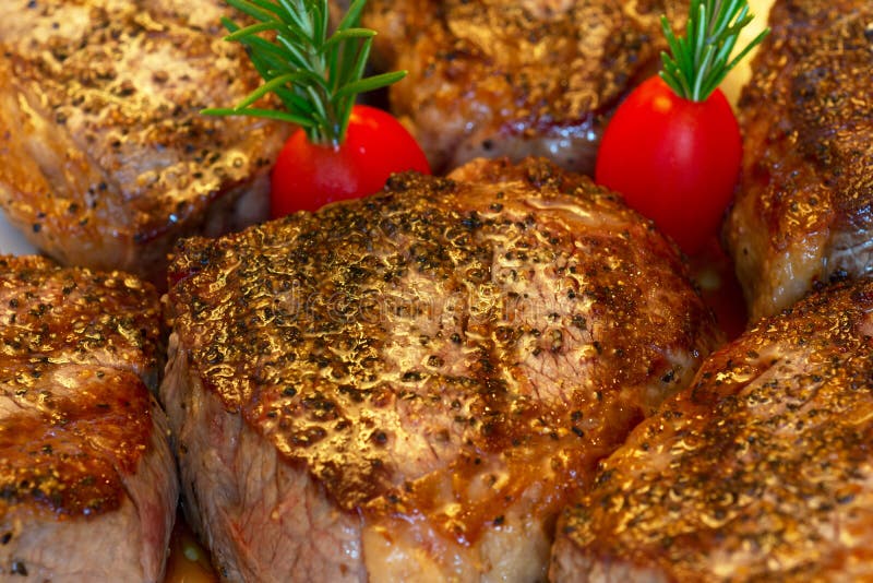 Organic tri tip steak freshly cooked and garnished with rosemary and cherry tomatoes. Organic tri tip steak freshly cooked and garnished with rosemary and cherry tomatoes