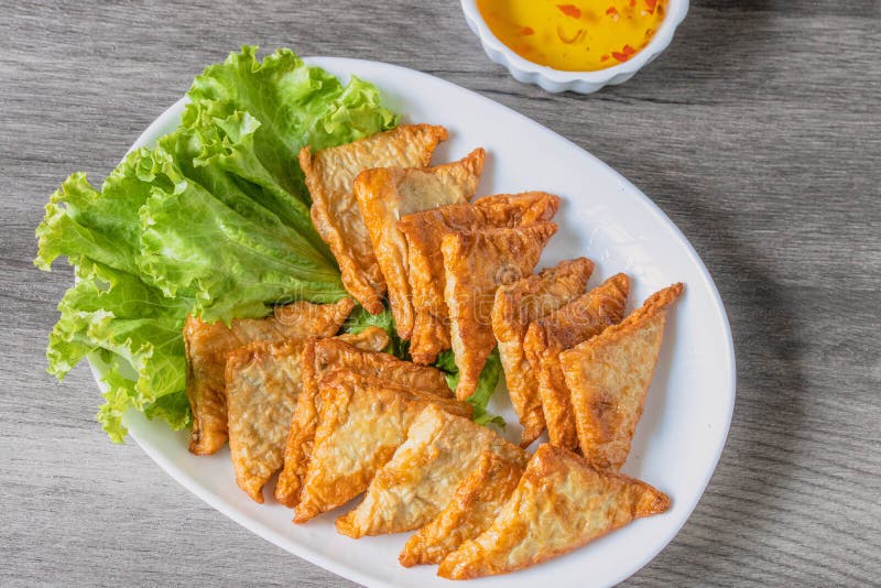 Triangular Fried Tofu Eating with Spicy Dipping Sauce, Sweet and Spicy Stock Photo Image of