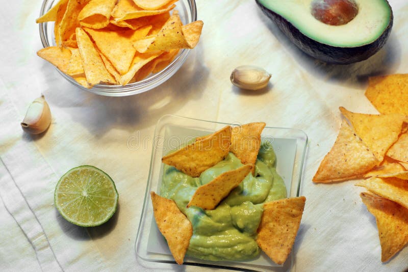 Triangular Nachos Chips in Sauce Made from Lime, Garlic and Avocado Stock Image