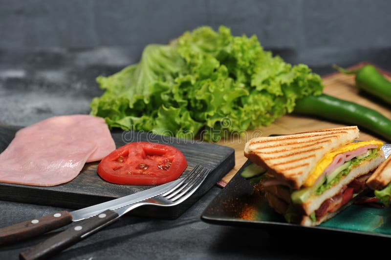 Triangular Shaped Sandwiches With Ham And Omelet On A Plate Stock Photo