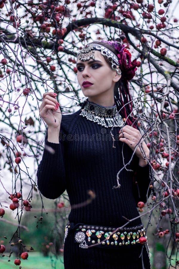 Tribal woman portrait outdoors in autumn trees