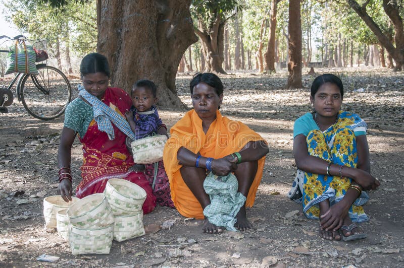 A Tribal women waiting under a tree. royalty free stock photo