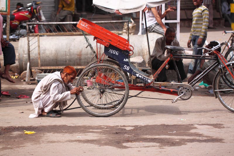 A Tricycle Driver is Having a Friendly Discussion with His Passenger in