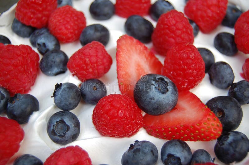 A trifle dessert topped with fresh strawberries, blueberries, raspberries and whipped cream. A trifle dessert topped with fresh strawberries, blueberries, raspberries and whipped cream