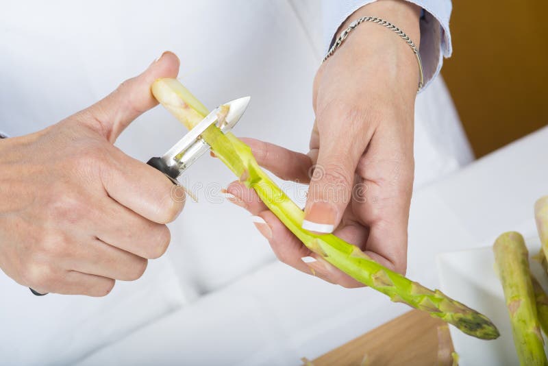 Trim and peel asparagus stock photo. Image of preparing 64438866