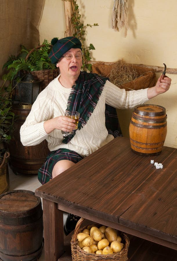 Trinkender Whisky des lustigen Scotsman stockfoto Trinkender Whisky des lustigen Scotsman stockfoto