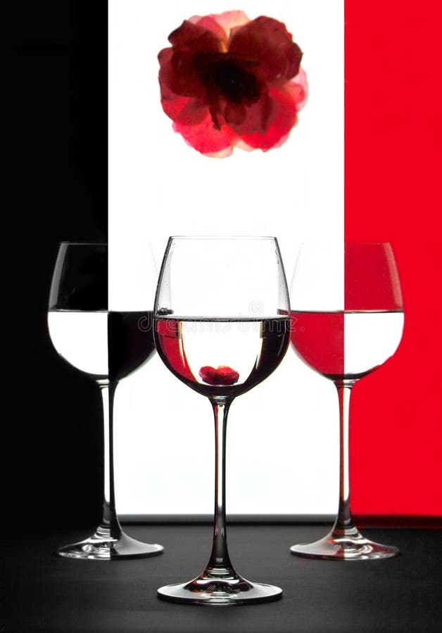 Three vine glasses with flower and red and black reflextions. Three vine glasses with flower and red and black reflextions