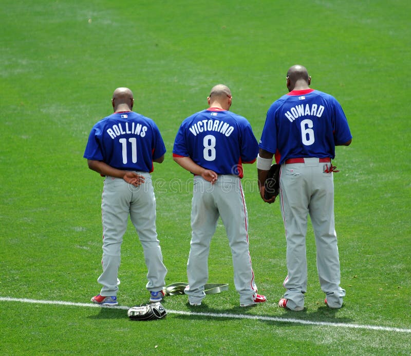 LAKE BUENA VISTA, FL - MARCH 24: Philadelphia Phillies stars Jimmy Rollins, Shane Victorino, and Ryan Howard (l-r) stand with heads bowed during the National Athem prior to the start of the March 24, 2010 spring training game in Lake Buena Vista, FL. LAKE BUENA VISTA, FL - MARCH 24: Philadelphia Phillies stars Jimmy Rollins, Shane Victorino, and Ryan Howard (l-r) stand with heads bowed during the National Athem prior to the start of the March 24, 2010 spring training game in Lake Buena Vista, FL.