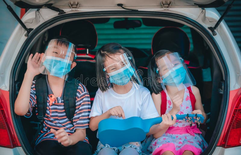 Trip coronavirus protect and social distancing concept, kids playing and singing song on car at home