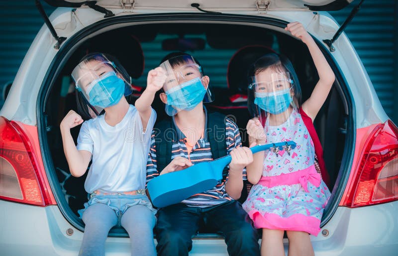 Trip coronavirus protect and social distancing concept, kids playing and singing song on car at home