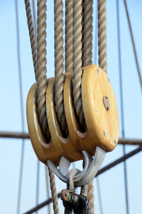 Triple pulley block among many other ropes on an old ship. Triple pulley block among many other ropes on an old ship