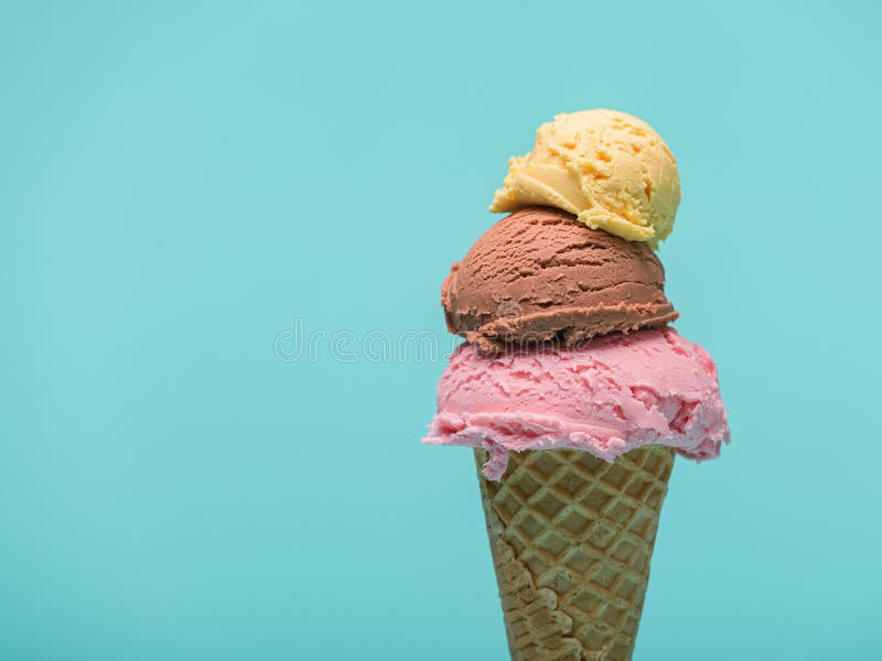Triple Scoop Ice Cream Cone on blue background stock photo