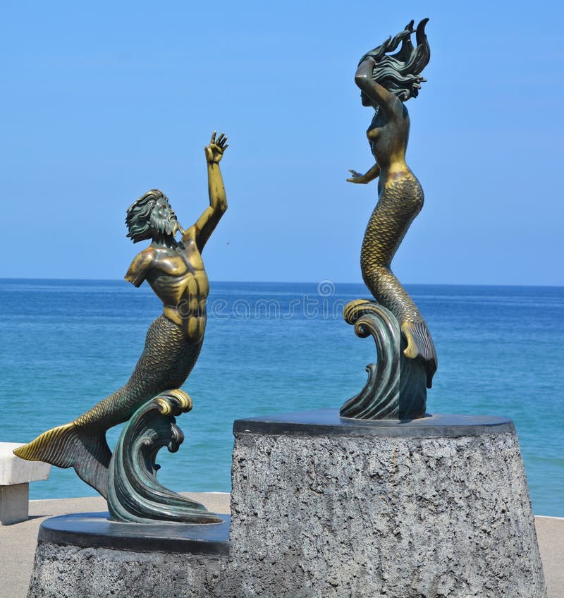 PUERTO VALLARTA MEXICO MAY 07 2016: Statue on the corner of Abasolo and the Malecon. This sculpture by Carlos Espino, Triton and Mermaid, concentrates on the human form and classical mythology,