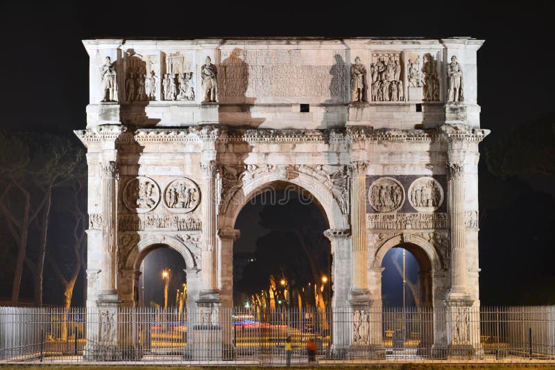 Triumphal Arch of Constantine nearby Colosseum in Rome against blue sky, Italy