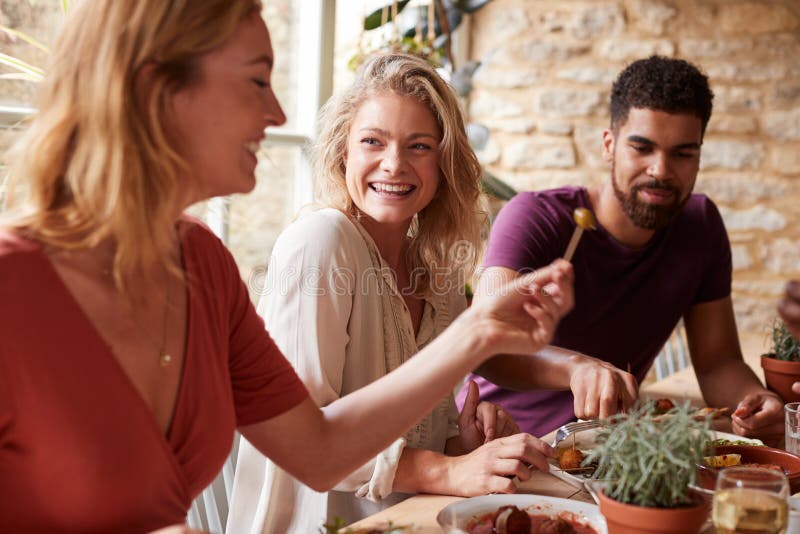 Three young friends having fun eating tapas at a restaurant. Three young friends having fun eating tapas at a restaurant