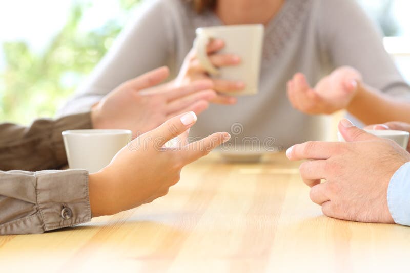 Close up of three friends hands talking sitting in a bar or house. Close up of three friends hands talking sitting in a bar or house