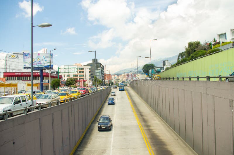 Trolley bus lane inner city Quito Ecuador on a sunny day with some random traffic.