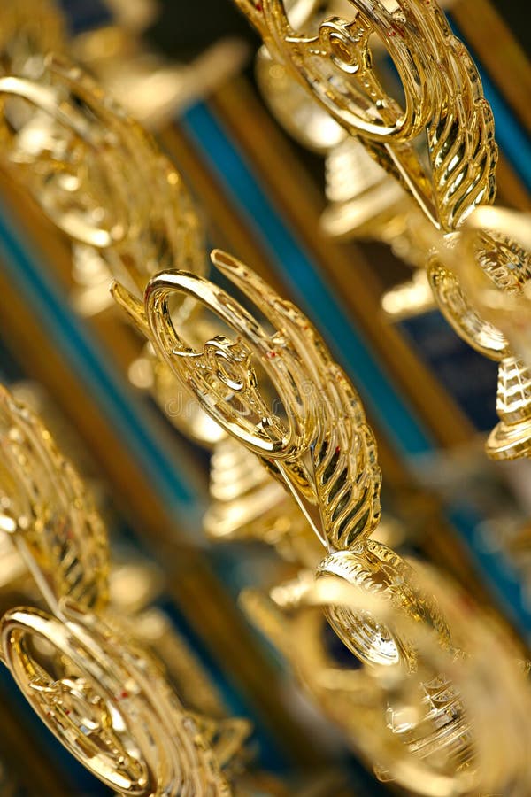 Trophies. Tops of trophies depicting steering wheels stock images