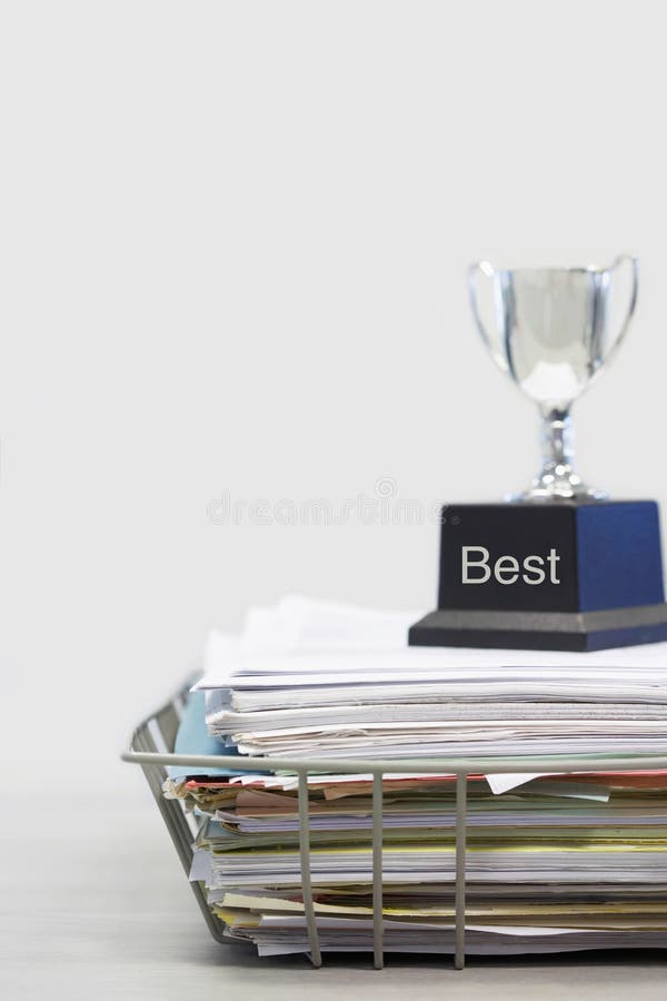 Trophy on Top of Papers saying best stock images Trophy on Top of Papers saying best stock images