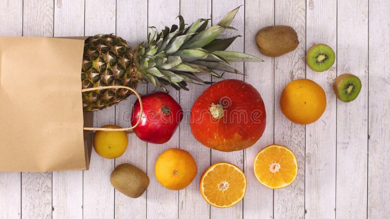 Tropic fresh fruits appear from the paper shopping bag. Stop motion