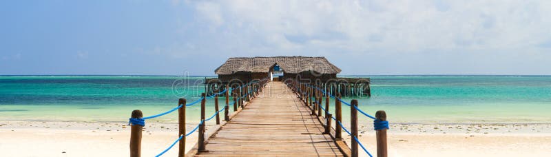 Wooden jetty on exotic beach of tropical Zanzibar island. Wooden jetty on exotic beach of tropical Zanzibar island