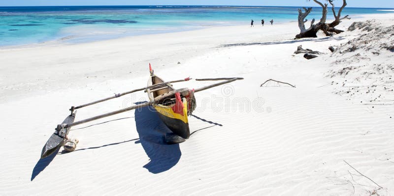 Tropical beach in Madagascar. White sand and traditional boat.