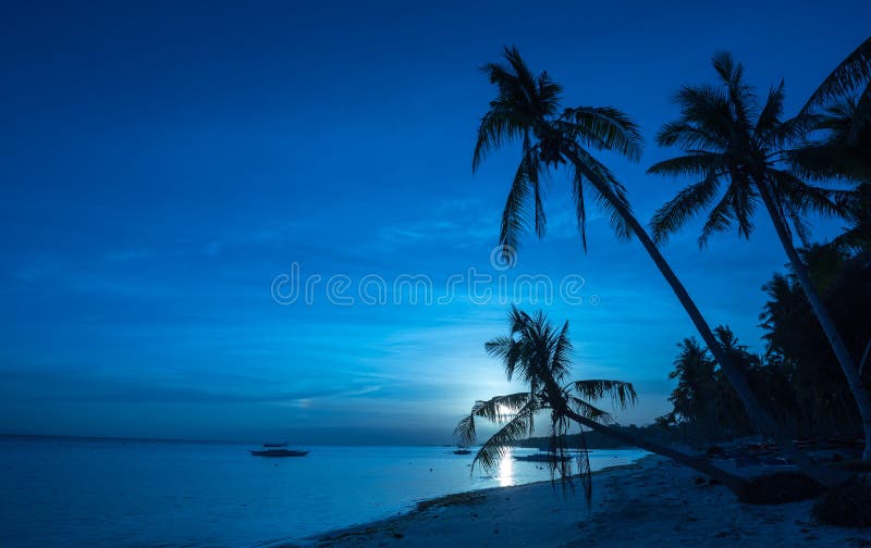 Tropical beach background of night view from Dumaluan Beach stock photo