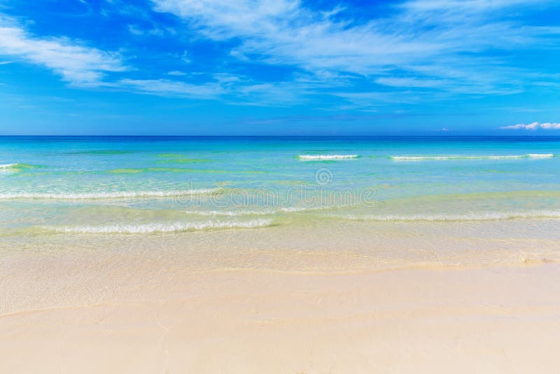 Tropical beach and beautiful sea. Blue sky with clouds in the ba