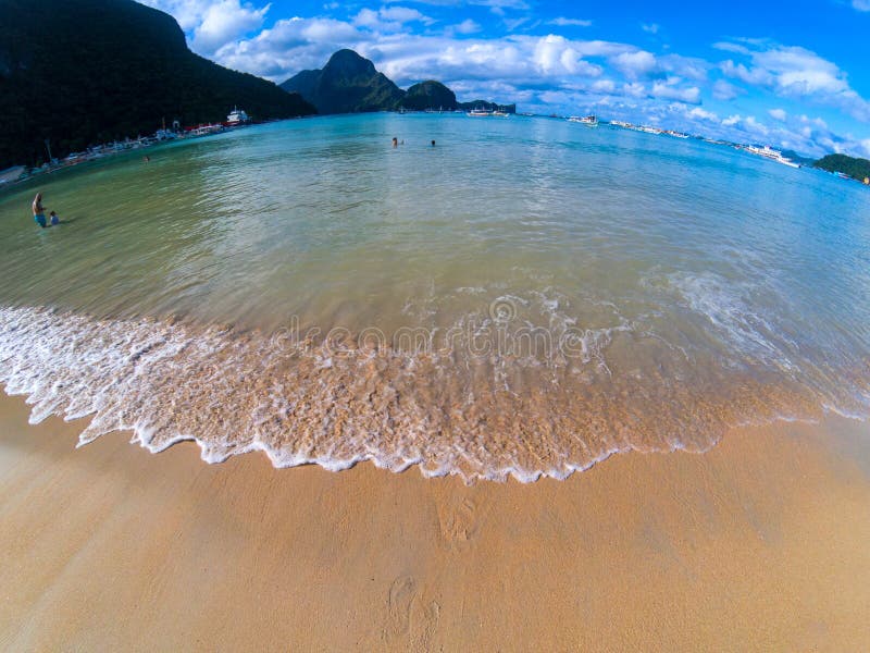 Tropical beach and blue sea water landscape. Idyllic beach in fisheye lens photo. Mountains and sea of Palawan island