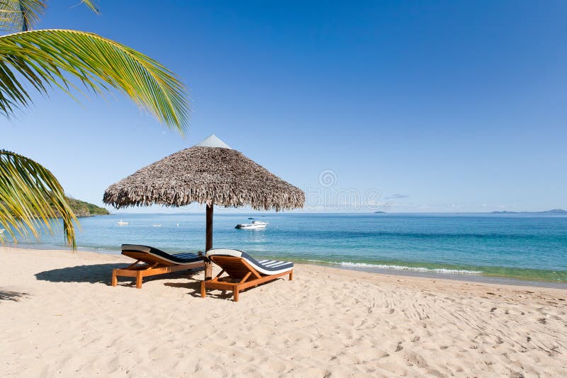 Tropical beach landscape with deckchair and parasol, from Nosy Be, Madagascar