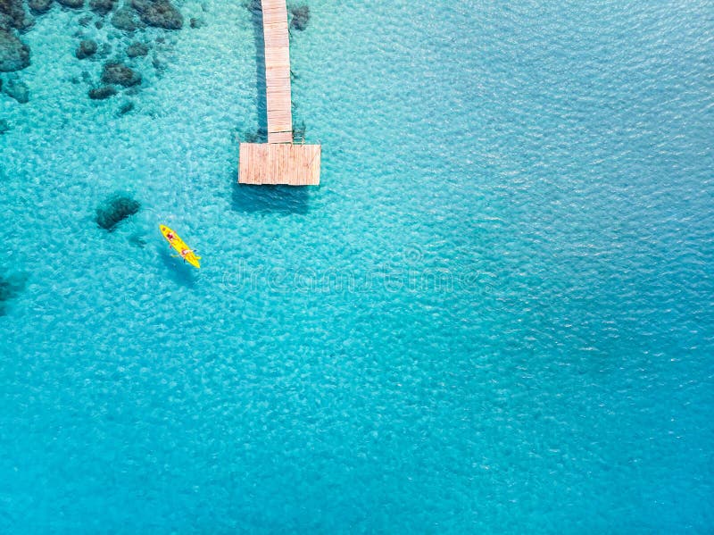 Tropical beach viewed from drone at beautiful vacation holidays destination with transparent turquoise sea water, pier and people royalty free stock photography Tropical beach viewed from drone at beautiful vacation holidays destination with transparent turquoise sea water, pier and people royalty free stock photography