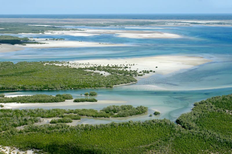 Aerial view of shallow coastal waters and forests of the tropical coast of Mozambique, southern Africa. Aerial view of shallow coastal waters and forests of the tropical coast of Mozambique, southern Africa