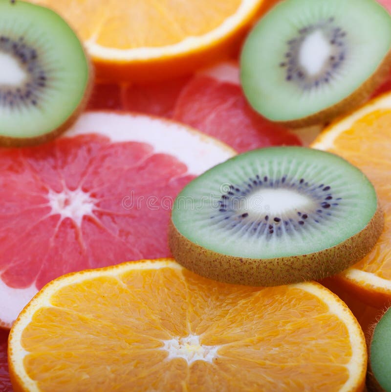 Tropical fruit cut circles as background royalty free stock photo