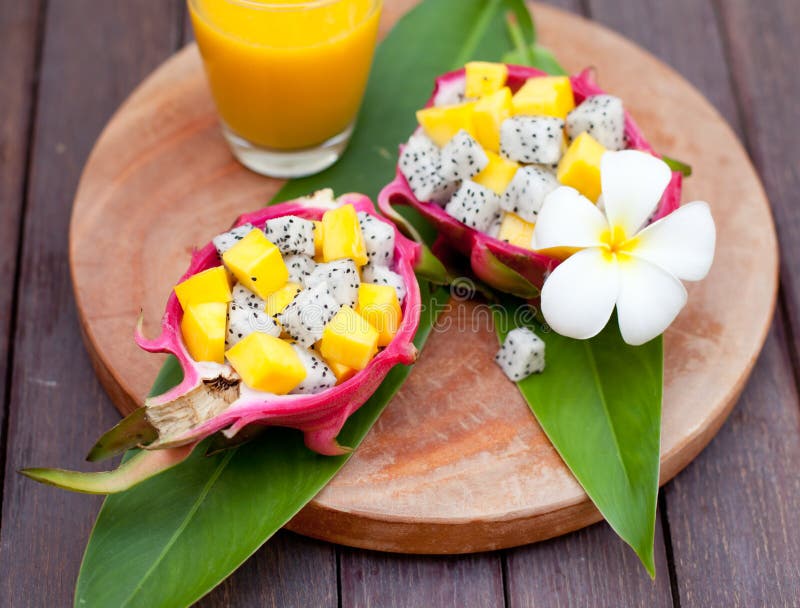Tropical fruit salad in pitahaya, dragon bowls with mango juice. stock photography Tropical fruit salad in pitahaya, dragon bowls with mango juice. stock photography
