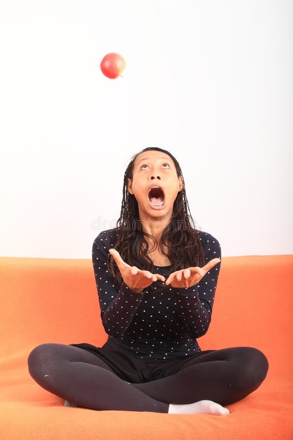 Tropical girl juggling with apple