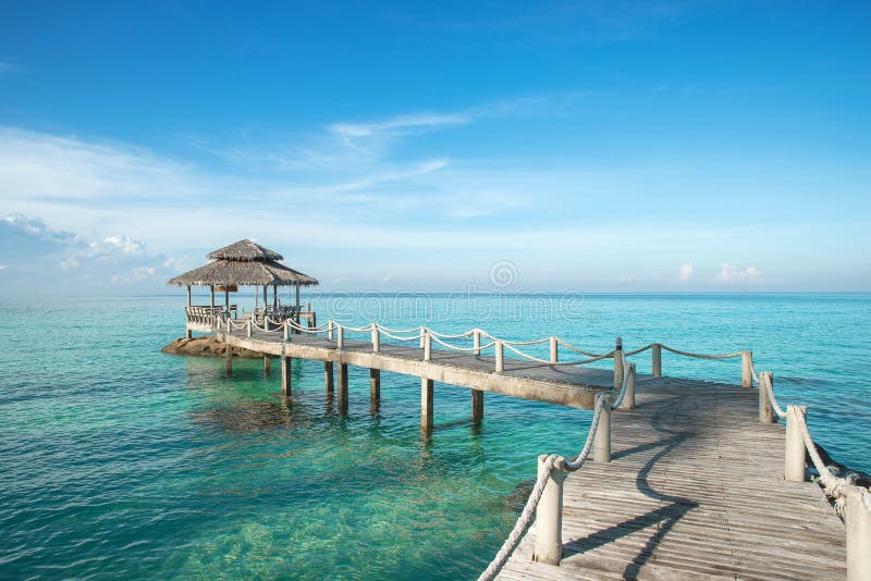 Tropical hut and wooden bridge at holiday resort - summer vacation background stock images Tropical hut and wooden bridge at holiday resort - summer vacation background stock images