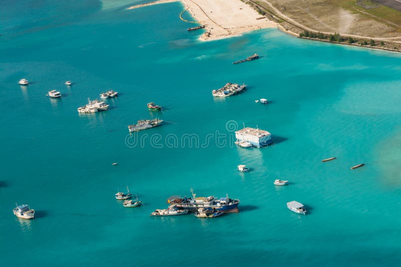 Tropical island harbor aerial view with boats and ships at Maldives
