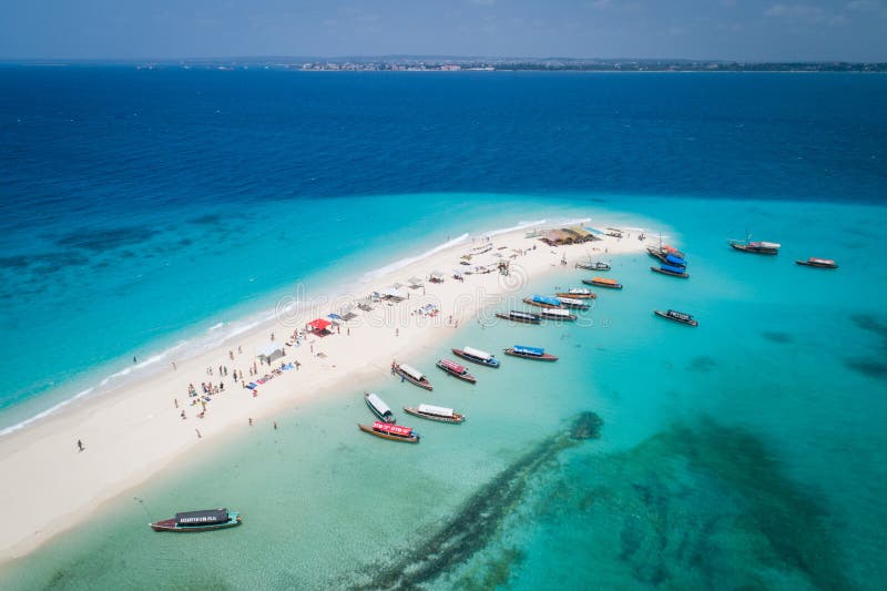 Aerial view of beautiful sand tropical island with white sand beach and tourists, Zanzibar. Aerial view of beautiful sand tropical island with white sand beach and tourists, Zanzibar