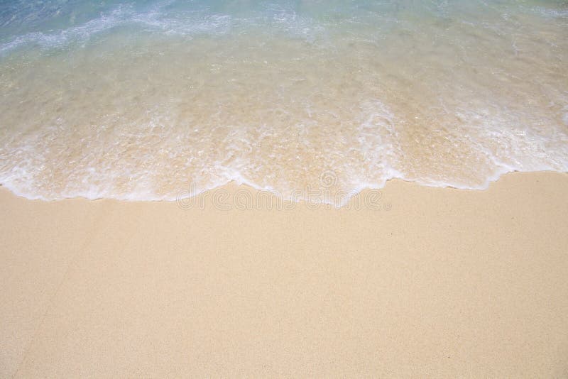 Background of tropical beach shoreline as wave runs up the sand. Background of tropical beach shoreline as wave runs up the sand.