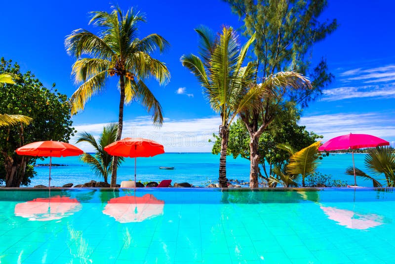 Tropical holidays,view with swimming pool ,sea and palm tree.Mauritius island. Tropical holidays,view with swimming pool ,sea and palm tree.Mauritius island.